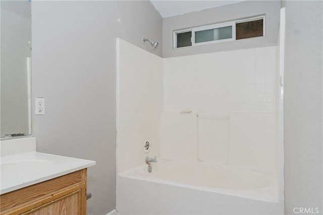 bathroom featuring  shower combination and vanity