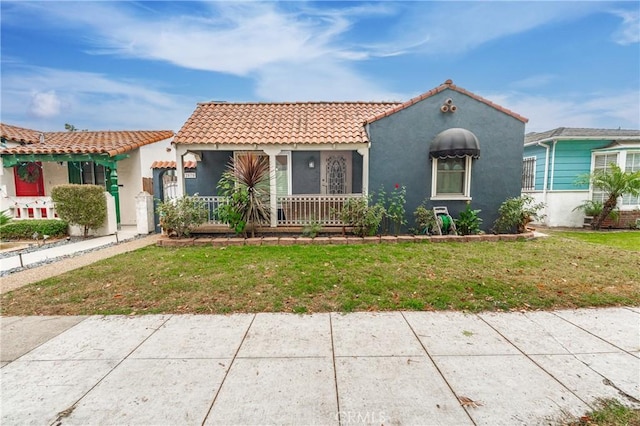 mediterranean / spanish home featuring a front lawn