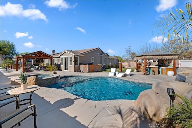 view of swimming pool featuring a gazebo, a patio area, exterior bar, and an in ground hot tub