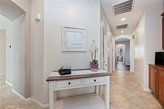 hall featuring light tile patterned floors