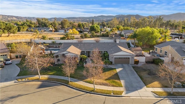 birds eye view of property featuring a mountain view