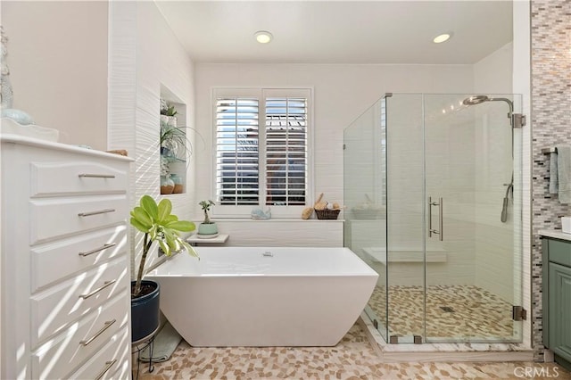 bathroom featuring shower with separate bathtub, vanity, and tile patterned flooring