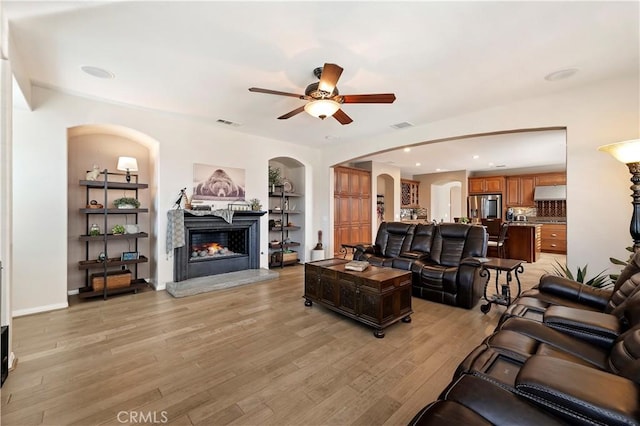 living room with light wood-type flooring and ceiling fan