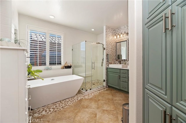 bathroom featuring independent shower and bath, tile patterned flooring, and vanity