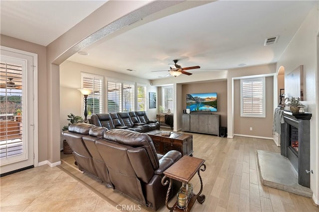 living room featuring light wood-type flooring and ceiling fan