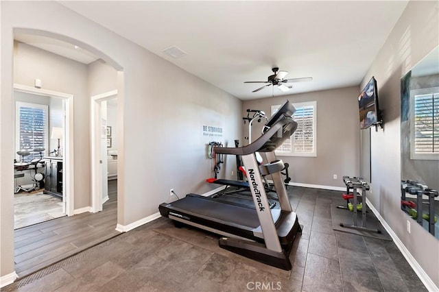 workout room featuring ceiling fan and dark hardwood / wood-style floors