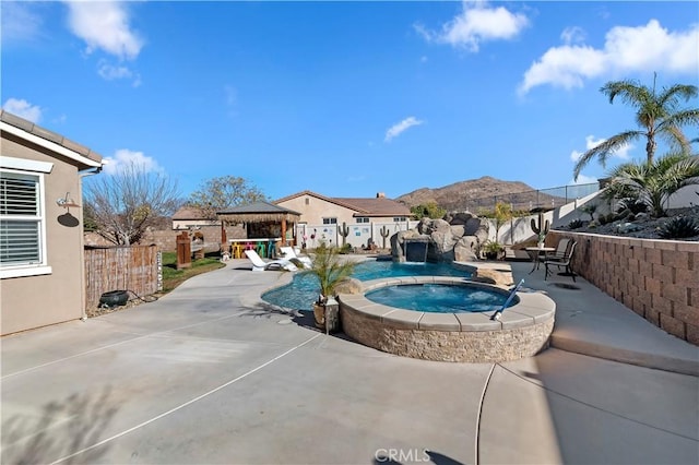 view of pool with a patio, a gazebo, an in ground hot tub, and a mountain view