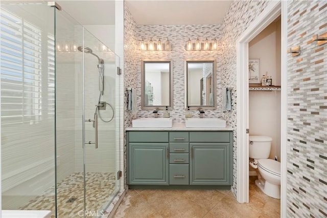 bathroom featuring tile patterned floors, an enclosed shower, vanity, and toilet