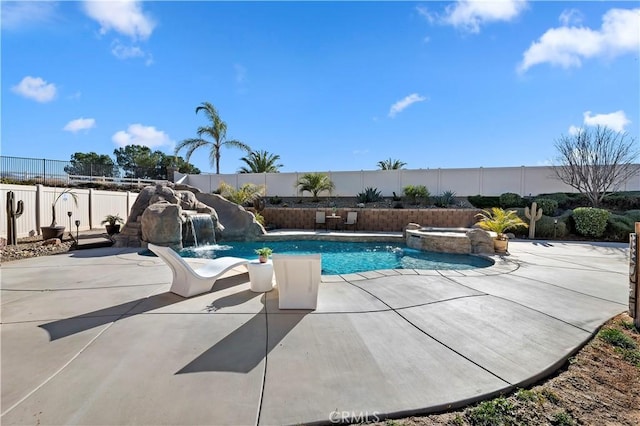 view of pool featuring pool water feature, an in ground hot tub, and a patio area