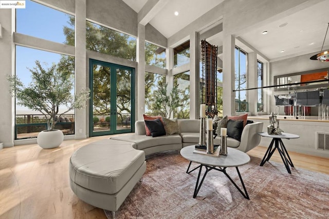 sunroom with french doors and lofted ceiling with beams