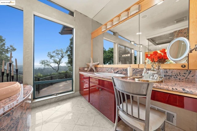 kitchen featuring light tile patterned floors, a healthy amount of sunlight, and sink