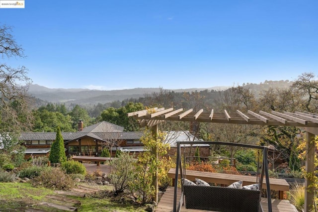 exterior space with a deck with mountain view