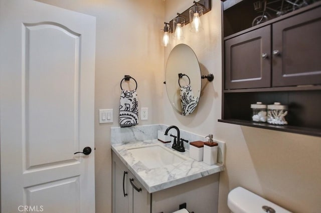 bathroom featuring toilet and vanity