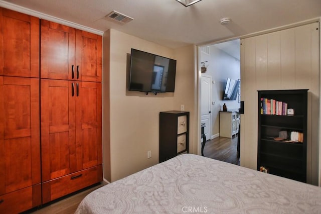 bedroom with dark wood-type flooring and a closet