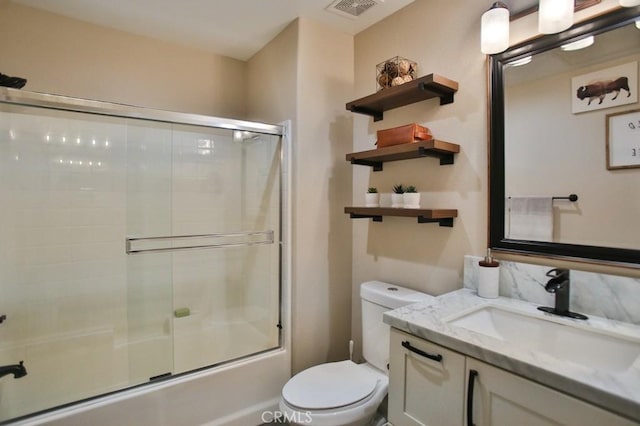 full bathroom with shower / bath combination with glass door, vanity, and toilet