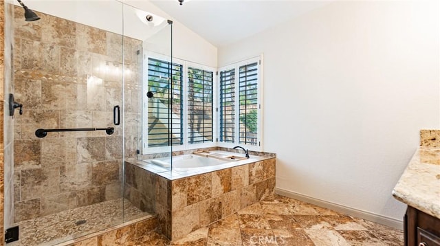 bathroom with vanity, separate shower and tub, and vaulted ceiling