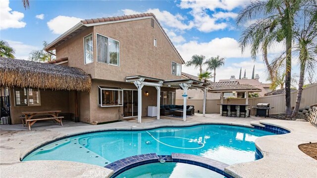 view of pool featuring an outdoor living space, a grill, a patio, and an in ground hot tub