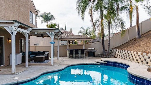 view of swimming pool featuring an outdoor living space, exterior bar, a patio area, and grilling area