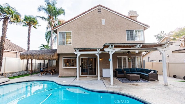 back of property featuring a patio, a pergola, a fenced in pool, an outdoor living space, and ceiling fan