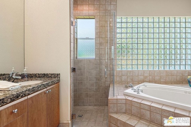 bathroom featuring separate shower and tub and vanity