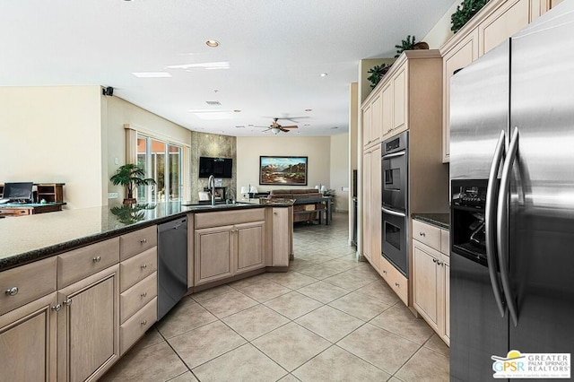 kitchen with light tile patterned floors, ceiling fan, stainless steel appliances, light brown cabinetry, and sink