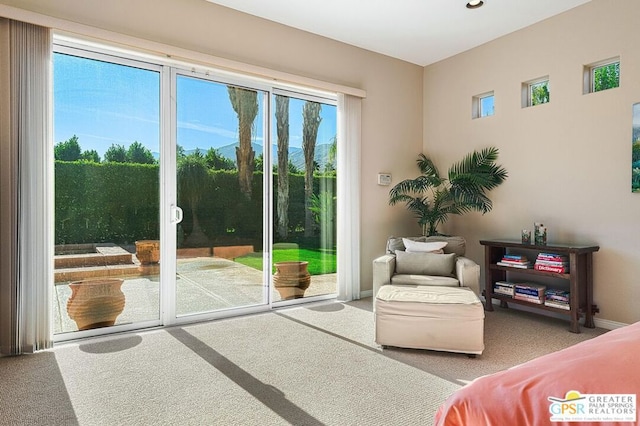 doorway to outside featuring carpet flooring and plenty of natural light