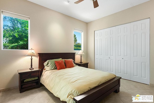 tiled bedroom with ceiling fan and a closet