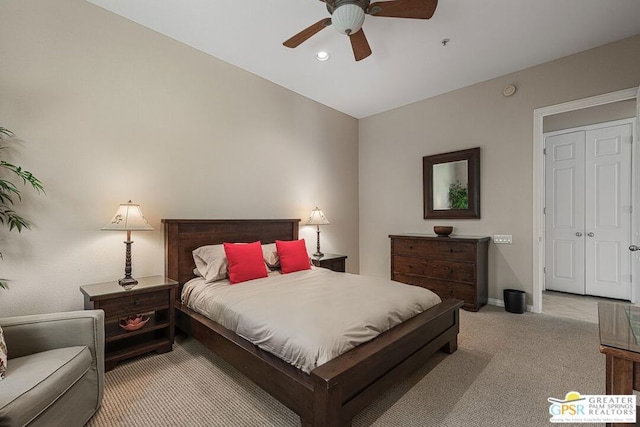 bedroom featuring ceiling fan, light colored carpet, and a closet