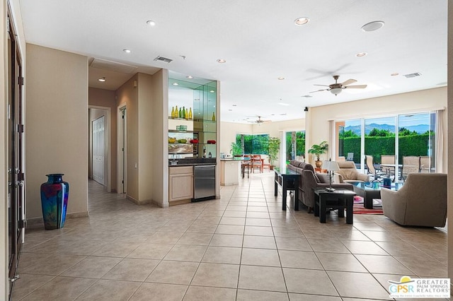 tiled living room with ceiling fan