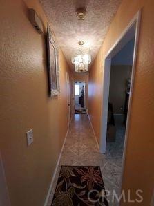 hallway featuring an inviting chandelier