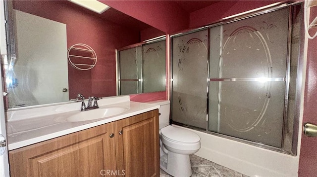 full bathroom featuring toilet, tile patterned floors, vanity, and shower / bath combination with glass door