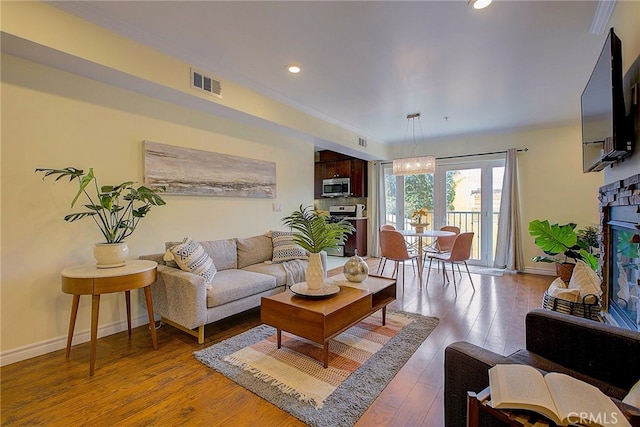 living room with a fireplace and hardwood / wood-style flooring