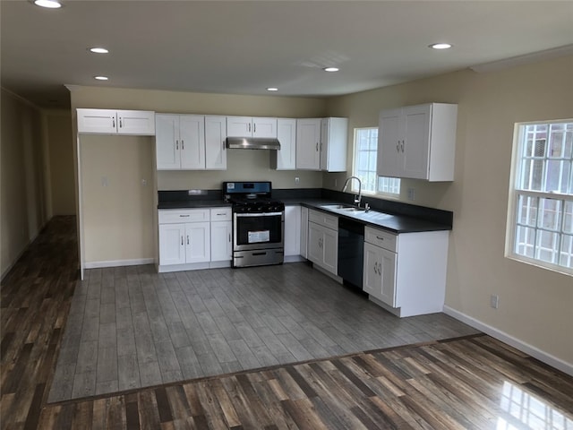 kitchen featuring dark hardwood / wood-style floors, sink, black dishwasher, stainless steel range, and white cabinets