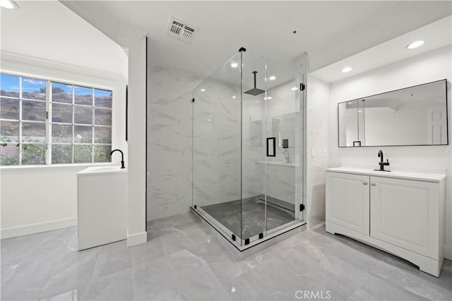 bathroom with walk in shower and vanity