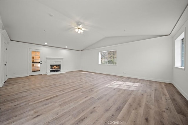 unfurnished living room featuring ceiling fan, lofted ceiling, and light wood-type flooring