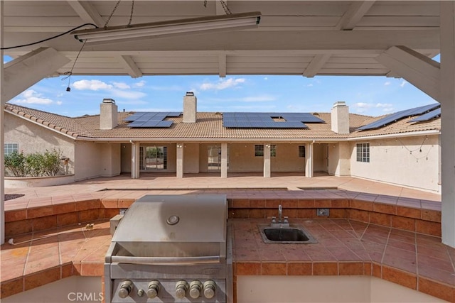 view of patio featuring sink and a grill