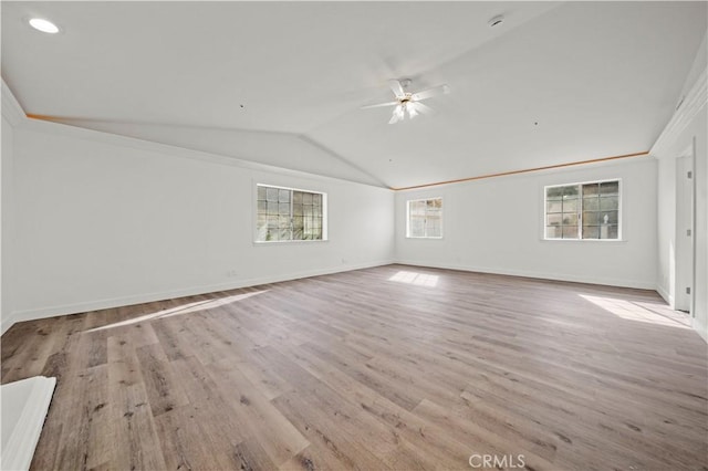 unfurnished room with ceiling fan, light hardwood / wood-style flooring, and lofted ceiling