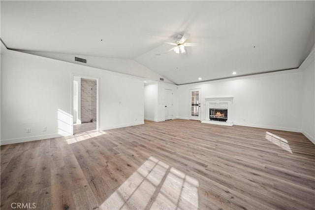 unfurnished living room featuring vaulted ceiling, ceiling fan, and light hardwood / wood-style floors