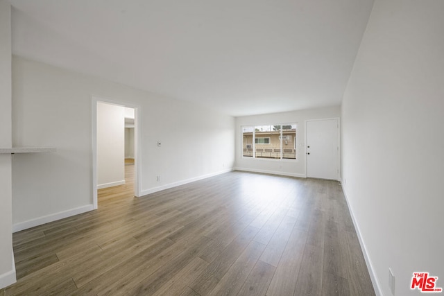 unfurnished living room featuring hardwood / wood-style flooring