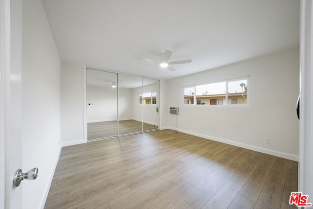 unfurnished bedroom with ceiling fan, a closet, and light hardwood / wood-style floors