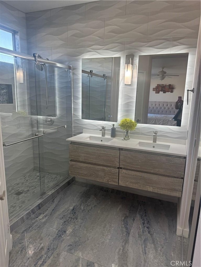 bathroom with vanity and a shower with door