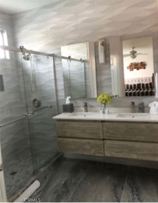 bathroom with an enclosed shower and vanity