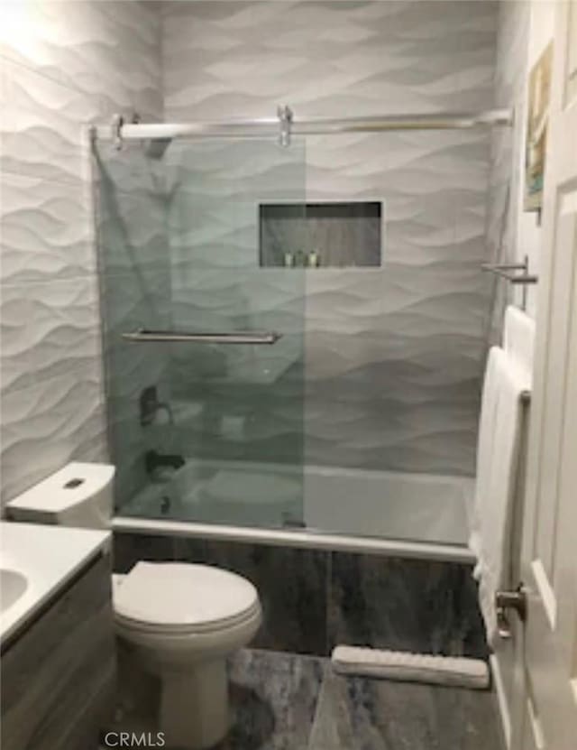 full bathroom with vanity, tiled shower / bath, and toilet