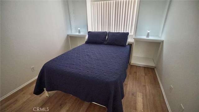 bedroom with hardwood / wood-style floors