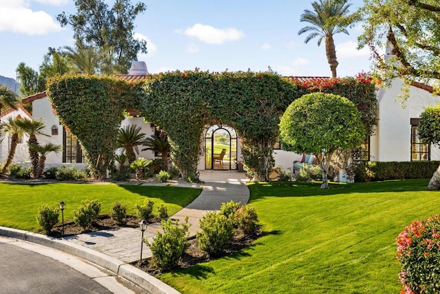 mediterranean / spanish home featuring a front yard