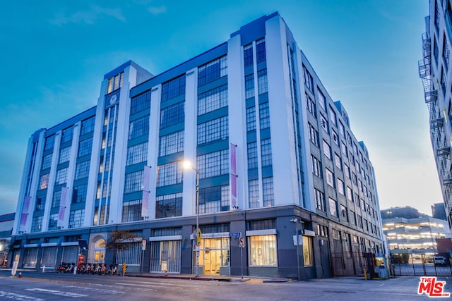 view of outdoor building at dusk