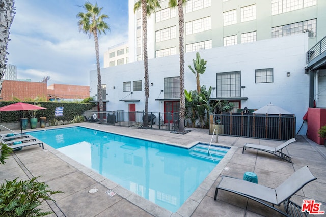 view of swimming pool featuring a patio area