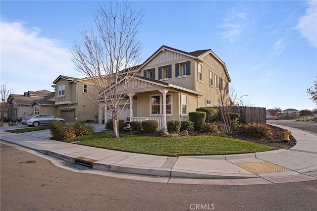 view of front property featuring a front lawn, a porch, and a garage