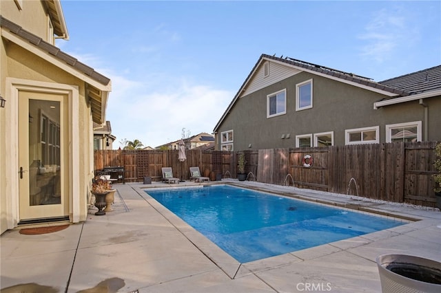 view of swimming pool featuring pool water feature and a patio