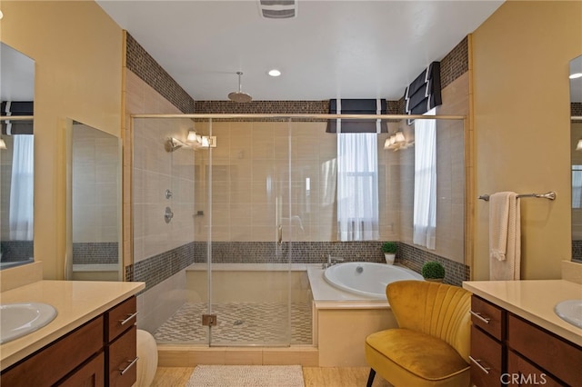 bathroom featuring independent shower and bath and vanity